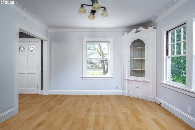 1856 SE Saint Andrews Dr, Portland, OR 97202 - unfurnished dining area featuring healthy amount of natural light, light wood-type flooring, crown molding, and baseboards