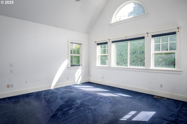 1856 SE Saint Andrews Dr, Portland, OR 97202 - spare room featuring plenty of natural light, high vaulted ceiling, baseboards, and dark carpet