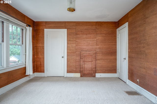 1856 SE Saint Andrews Dr, Portland, OR 97202 - unfurnished room featuring light carpet and wood walls