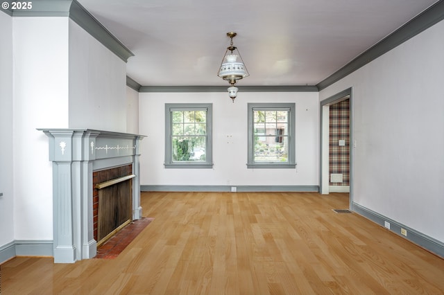 1856 SE Saint Andrews Dr, Portland, OR 97202 - unfurnished living room with a fireplace, wood finished floors, baseboards, and ornamental molding