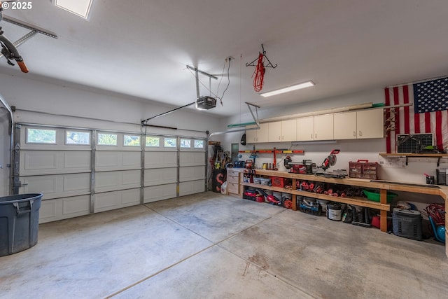 garage with a garage door opener and a workshop area