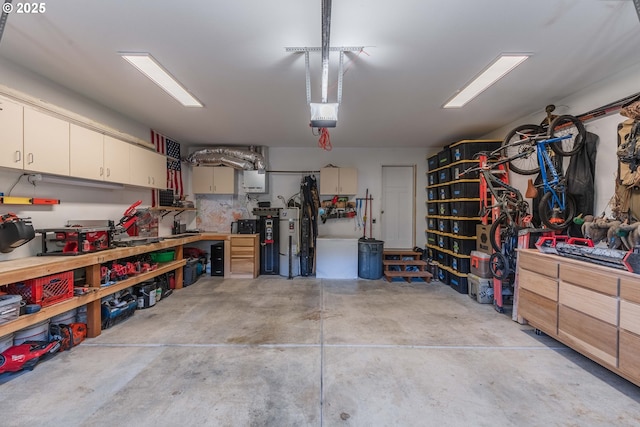 garage with a workshop area and a garage door opener