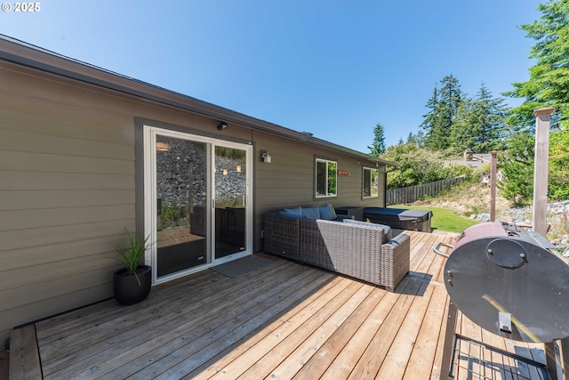 wooden terrace with grilling area, an outdoor living space, and fence
