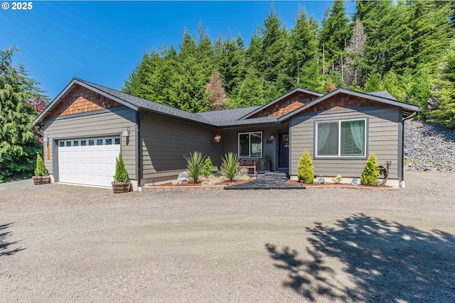 ranch-style home with an attached garage, a shingled roof, and driveway