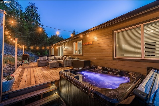 deck with a hot tub and an outdoor hangout area