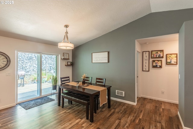 dining area with wood finished floors, baseboards, lofted ceiling, and visible vents