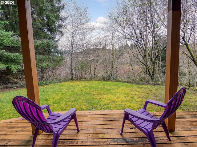 wooden deck featuring a lawn