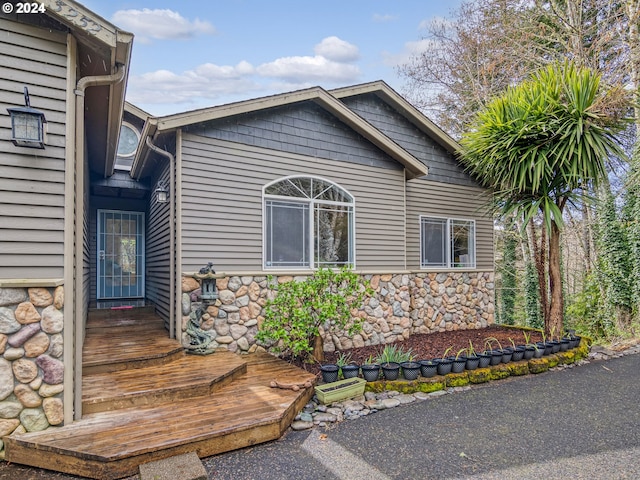 exterior space with stone siding