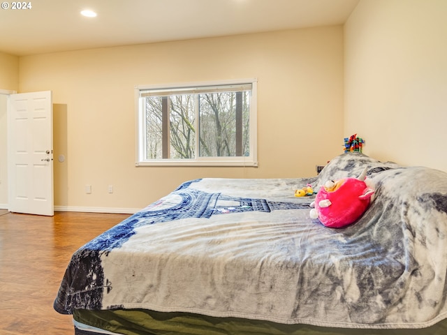 bedroom with recessed lighting, baseboards, and wood finished floors