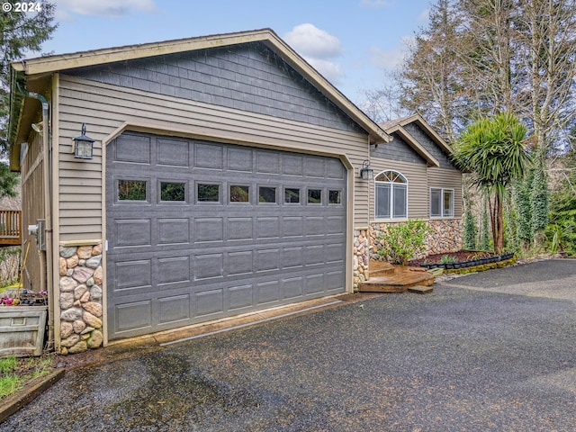 garage featuring aphalt driveway