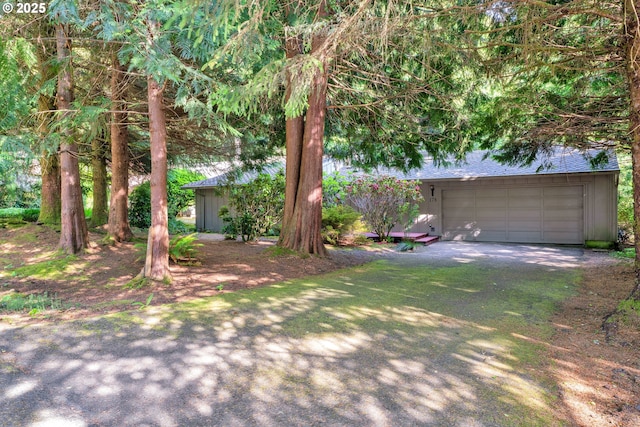178 SW The Pines Dr, Depoe Bay, OR 97341 - view of yard featuring dirt driveway and a garage