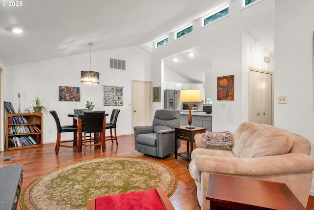 178 SW The Pines Dr, Depoe Bay, OR 97341 - living area featuring light wood-type flooring, high vaulted ceiling, and a chandelier