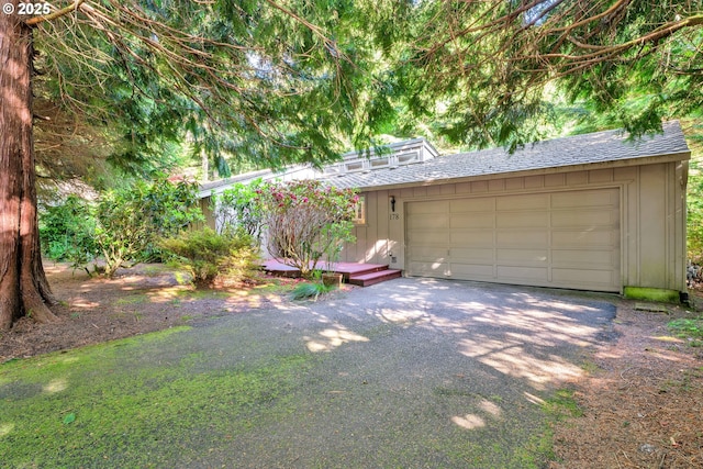 178 SW The Pines Dr, Depoe Bay, OR 97341 - view of front facade featuring board and batten siding, roof with shingles, and a garage