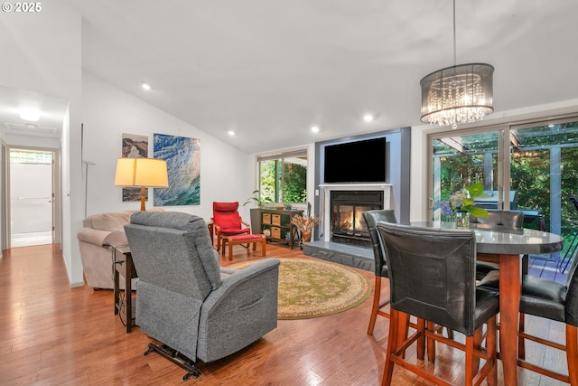 178 SW The Pines Dr, Depoe Bay, OR 97341 - living room with wood finished floors, recessed lighting, a glass covered fireplace, a chandelier, and lofted ceiling