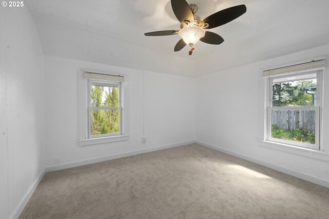 carpeted spare room with baseboards and ceiling fan