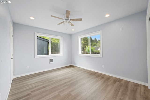 unfurnished room with light wood-type flooring, a ceiling fan, visible vents, and recessed lighting