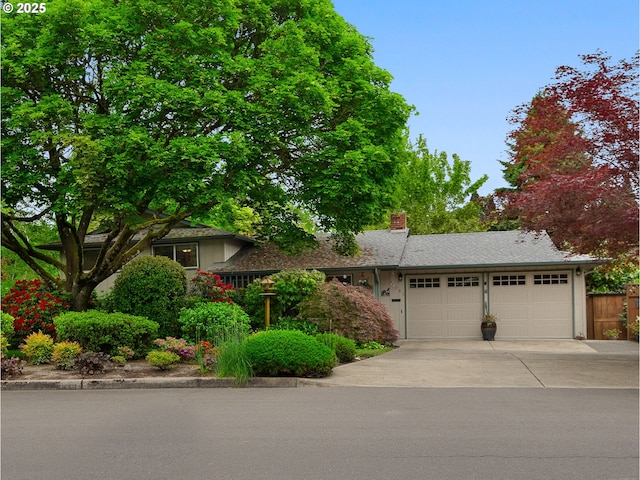 19085 SW Jaylee St, Beaverton, OR 97078 - view of front facade featuring a garage, driveway, and a chimney