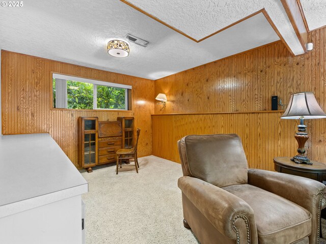 19085 SW Jaylee St, Beaverton, OR 97078 - sitting room featuring wood walls, a textured ceiling, and carpet