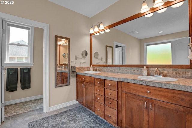 full bath featuring a sink, double vanity, and a wealth of natural light