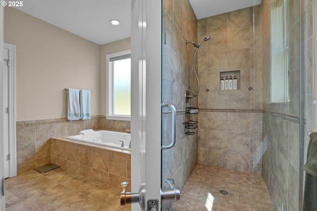 bathroom featuring a shower stall, recessed lighting, and a bath