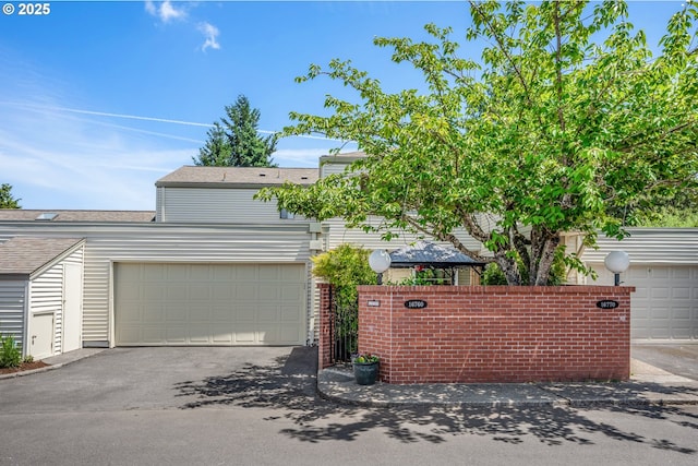 16760 SW Monaco Ln, Portland, OR 97224 - view of front of home with asphalt driveway, a garage, and roof with shingles