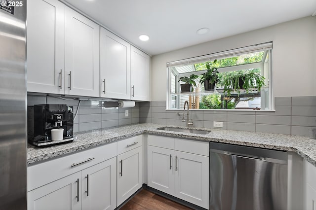 16760 SW Monaco Ln, Portland, OR 97224 - kitchen featuring appliances with stainless steel finishes, white cabinets, backsplash, light stone countertops, and recessed lighting