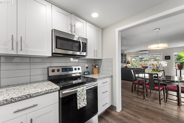 16760 SW Monaco Ln, Portland, OR 97224 - kitchen featuring appliances with stainless steel finishes, a wall mounted AC, white cabinets, dark wood-style floors, and tasteful backsplash