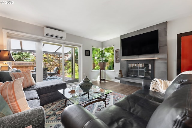 16760 SW Monaco Ln, Portland, OR 97224 - living area with a wall unit AC, wood finished floors, and a fireplace