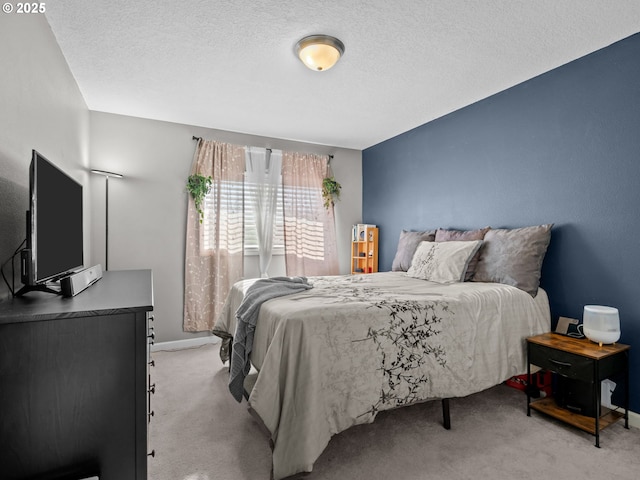 carpeted bedroom featuring a textured ceiling