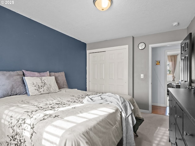 bedroom featuring a textured ceiling and a closet