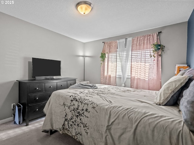 carpeted bedroom featuring a textured ceiling