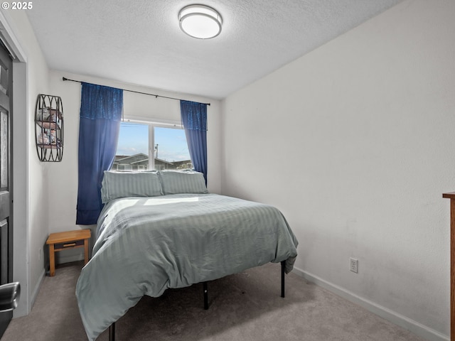 bedroom with carpet flooring and a textured ceiling