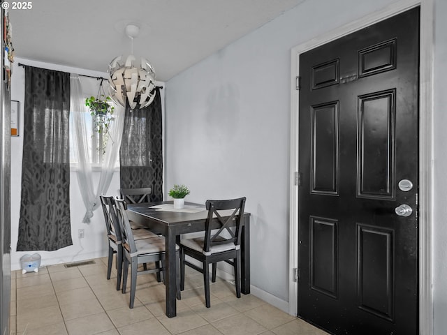 dining space featuring a chandelier and light tile patterned floors