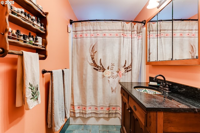 full bath with curtained shower, tile patterned flooring, and vanity