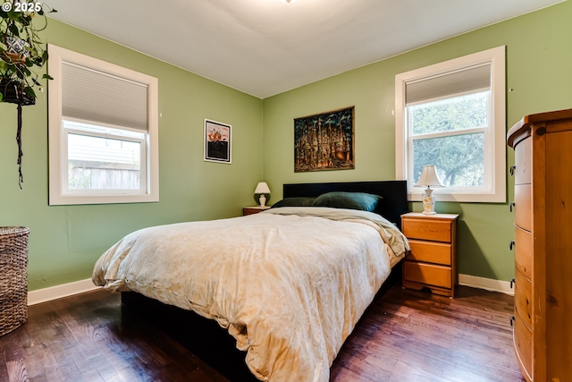 bedroom featuring baseboards and dark wood-style floors