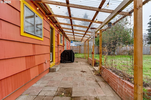 view of patio featuring a fenced backyard, a pergola, and grilling area