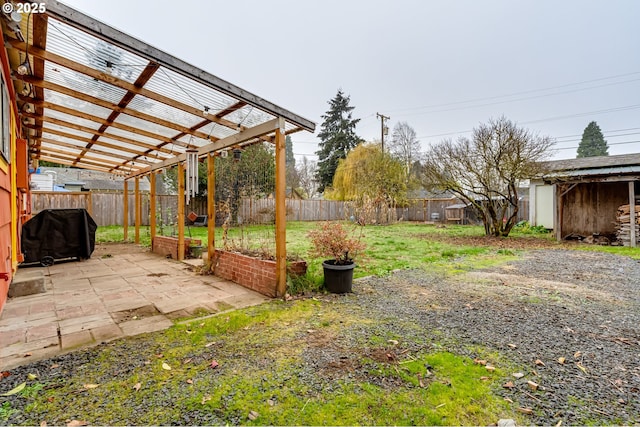view of yard with a pergola, a fenced backyard, and a patio area