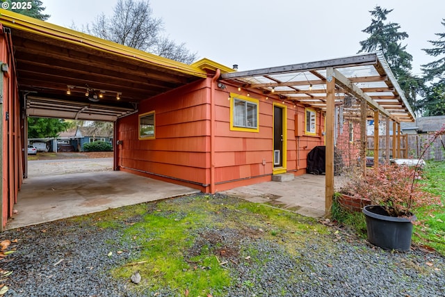 exterior space with fence and an attached carport