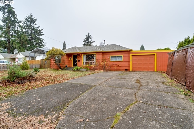 view of front of property with a garage, fence, and driveway