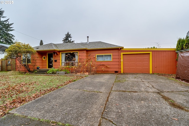 ranch-style home with an attached garage and driveway