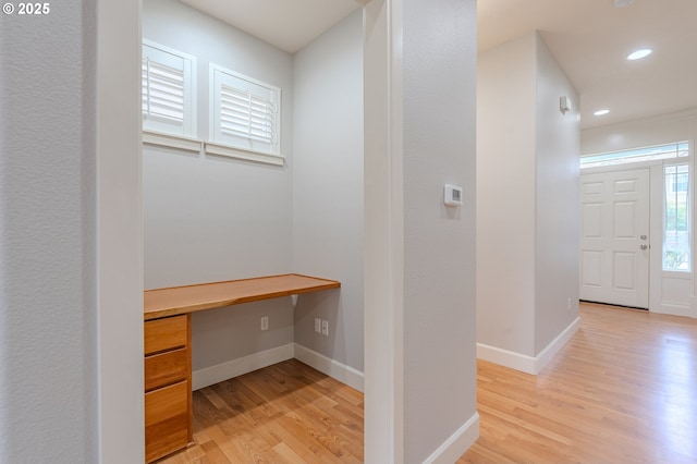 corridor with light hardwood / wood-style floors