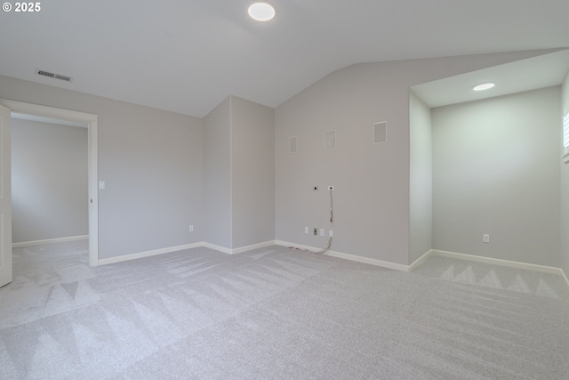 carpeted spare room featuring lofted ceiling