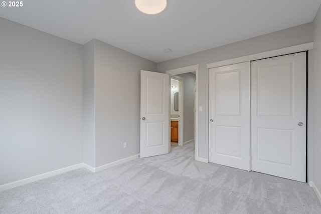 unfurnished bedroom with light carpet and a closet