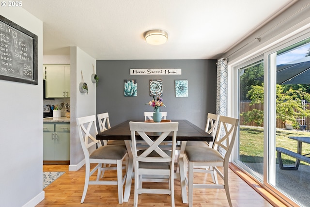1448 S Grove Lane Ct, Sutherlin, OR 97479 - dining space featuring light wood-style floors and baseboards