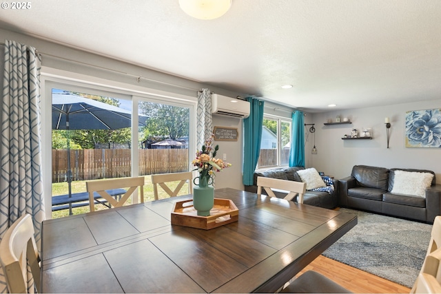 1448 S Grove Lane Ct, Sutherlin, OR 97479 - dining area with an AC wall unit, wood finished floors, and recessed lighting