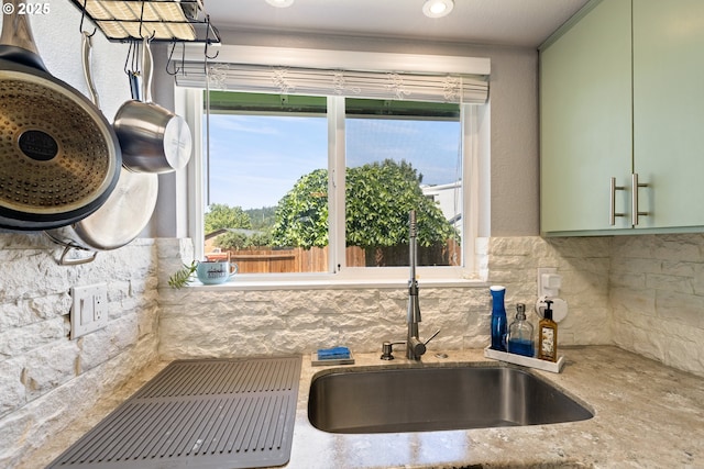1448 S Grove Lane Ct, Sutherlin, OR 97479 - kitchen featuring green cabinets, a sink, healthy amount of natural light, and backsplash