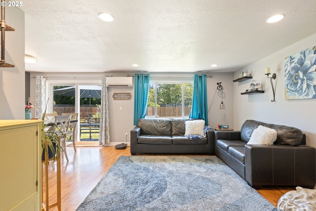 1448 S Grove Lane Ct, Sutherlin, OR 97479 - living room featuring an AC wall unit, wood finished floors, a textured ceiling, and recessed lighting
