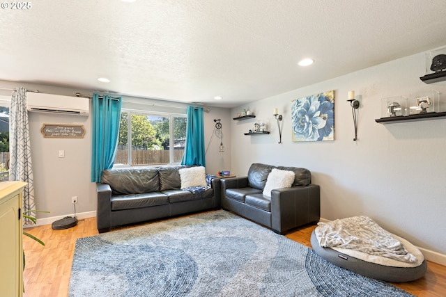 1448 S Grove Lane Ct, Sutherlin, OR 97479 - living area with an AC wall unit, light wood-style floors, baseboards, recessed lighting, and a textured ceiling