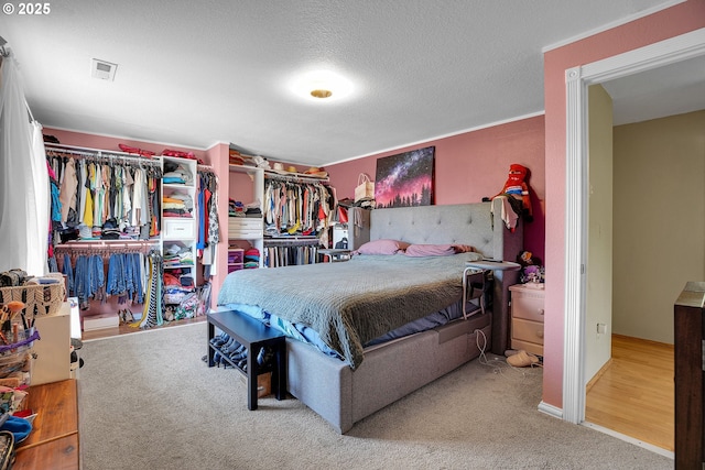 bedroom with carpet flooring and a textured ceiling