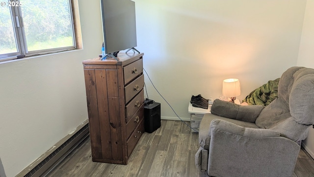 sitting room featuring dark wood-style flooring and baseboards